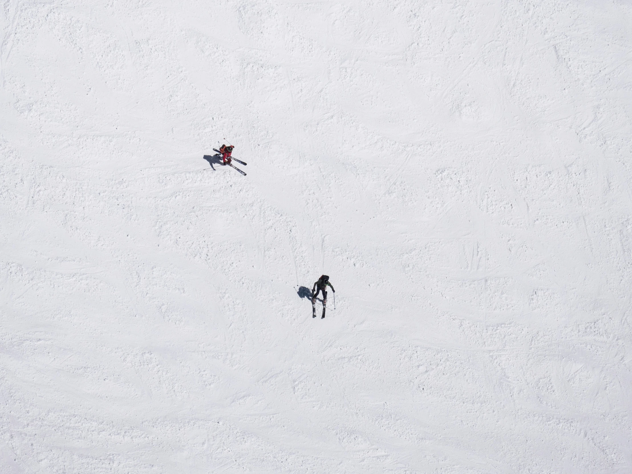 two people snow skiing in the snow on skis