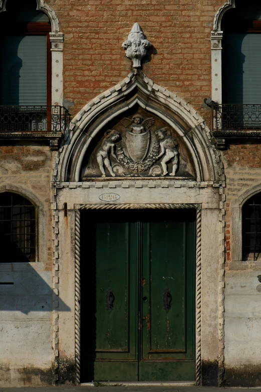 large doorway with carving above, and below, at an old building