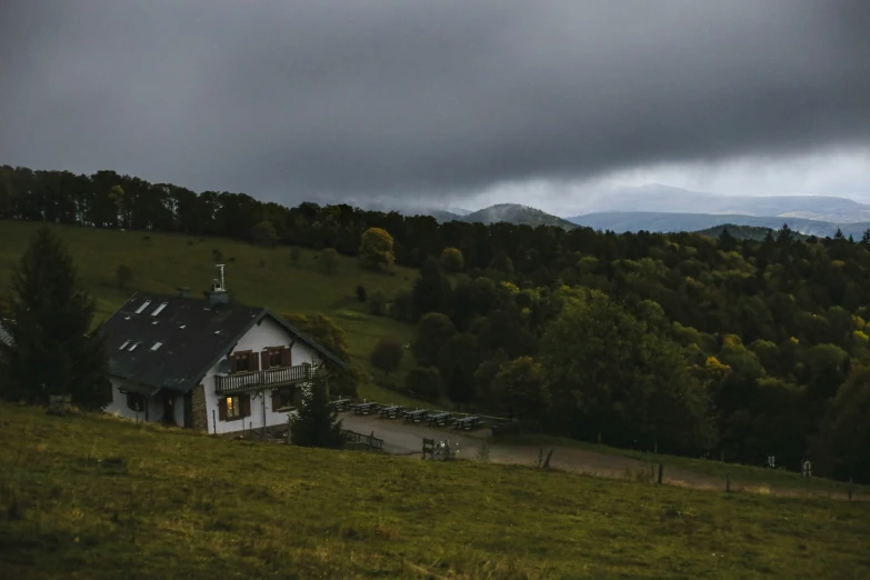 a large home sits on a green mountain