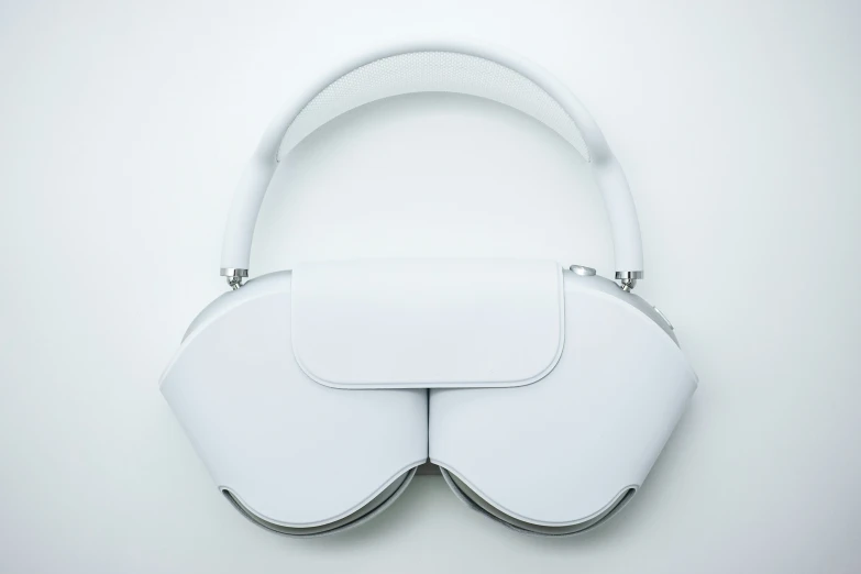 a white purse with matching handles is mounted on a wall