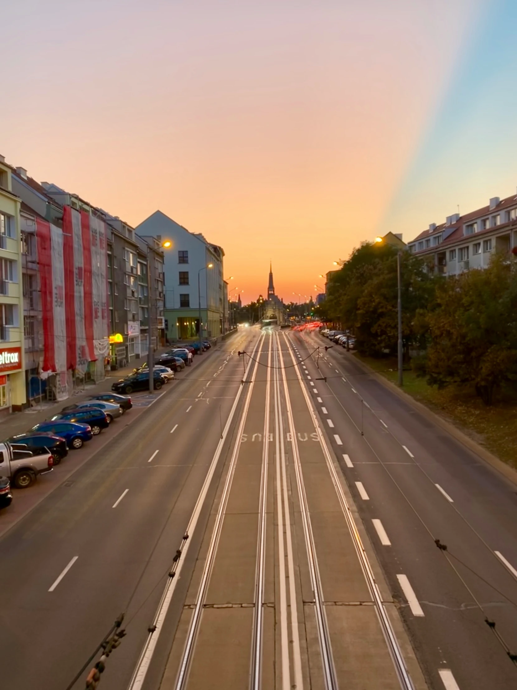 the view of a street and buildings from an elevated viewpoint