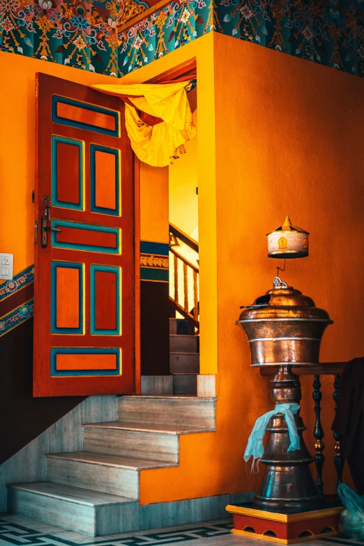 stairs going up to an open door in a colorful building