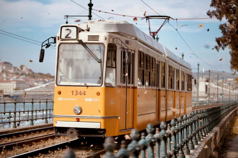 yellow trolley train on its way to the city