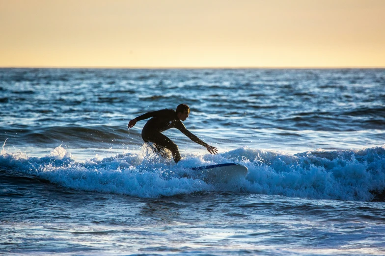 a man riding a wave on top of a surfboard