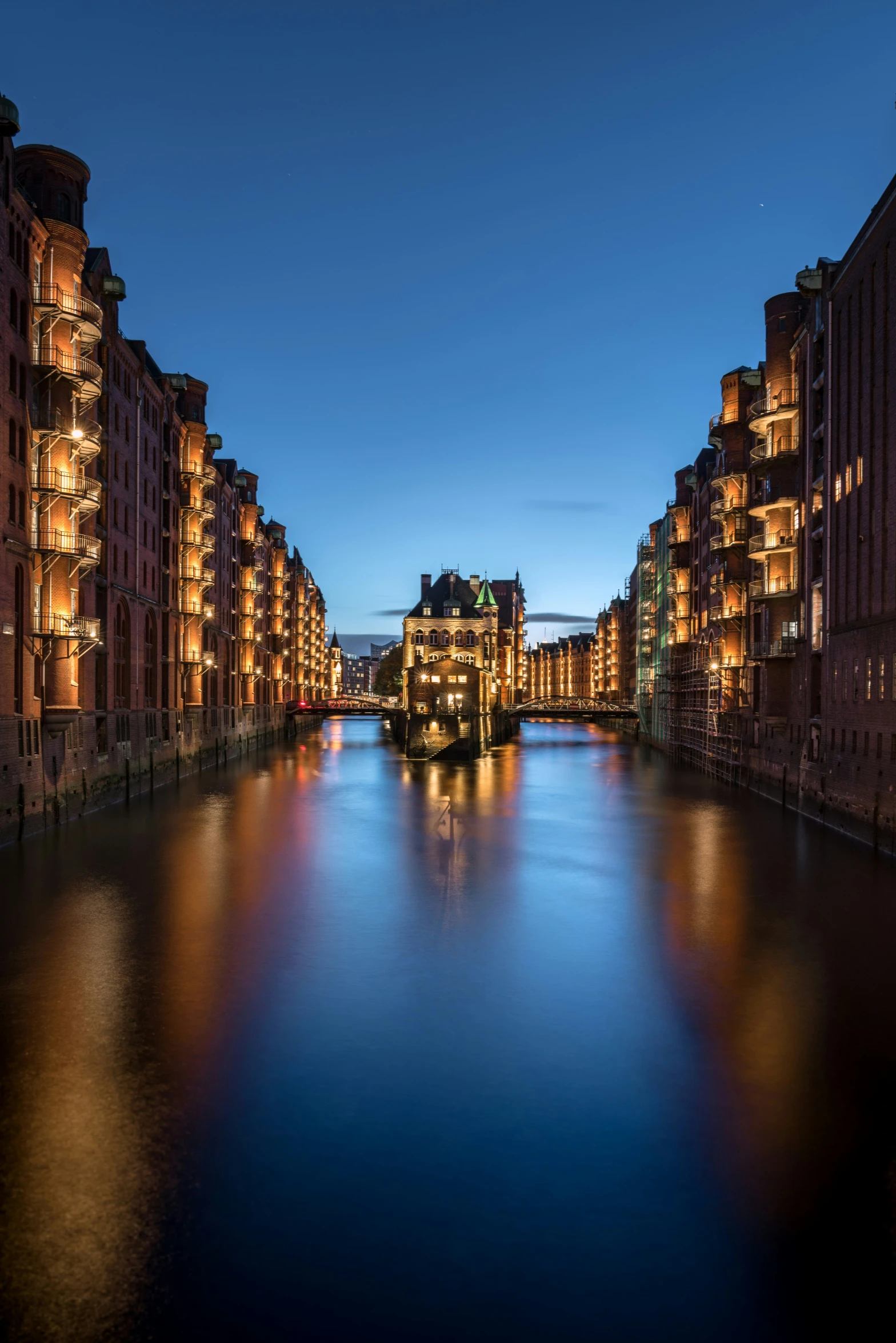 a waterway next to tall building at dusk