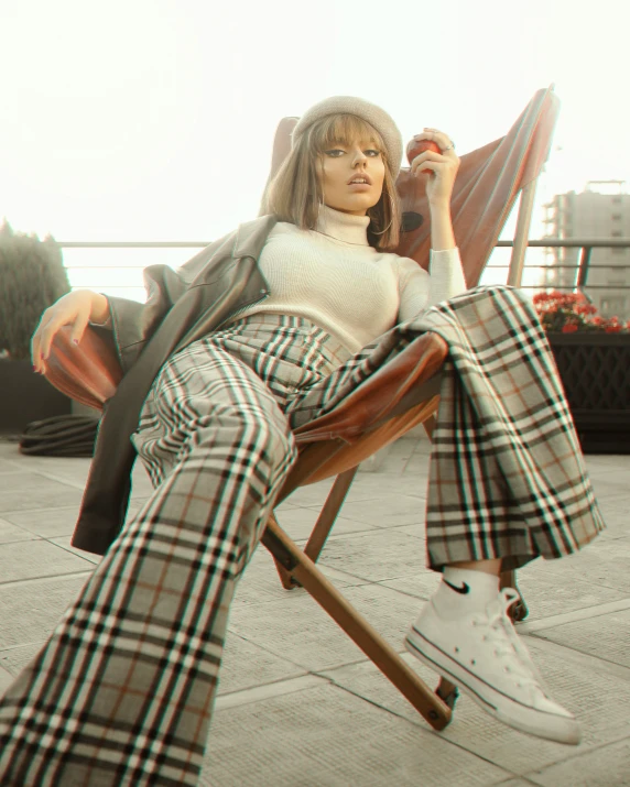 a 3d pograph of a woman sitting on top of a wooden chair