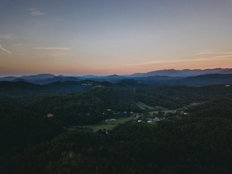 an aerial view of some hills and houses