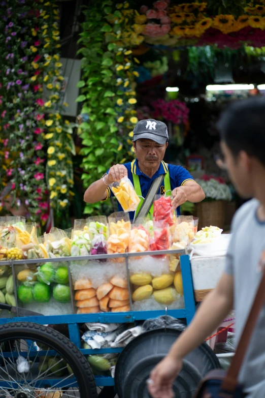 a man stands at a produce market holding a bag