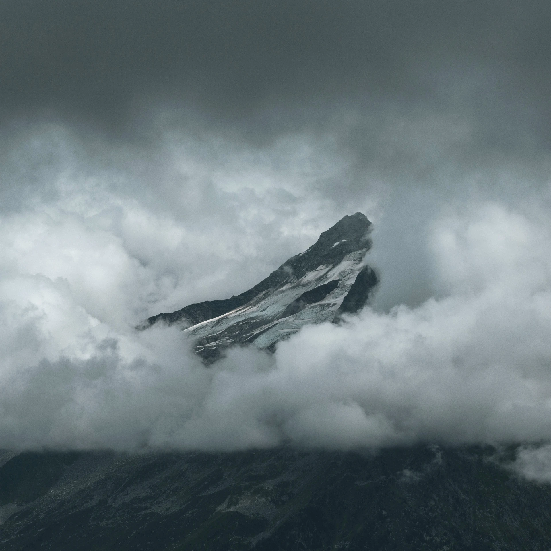 a mountain covered in clouds, with a sky line