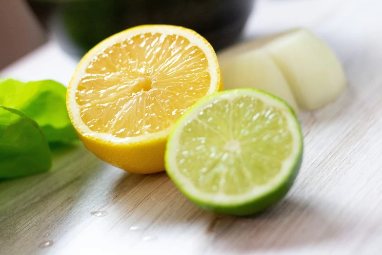 a slice of lime next to a sliced lemon, mint and a lime