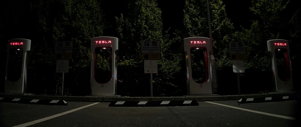 five electric cars charging next to each other