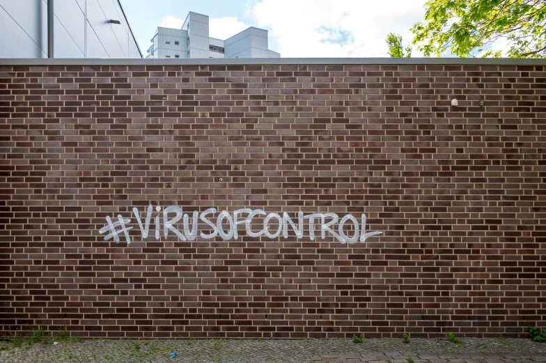 graffiti on the side of a brick wall in an urban setting