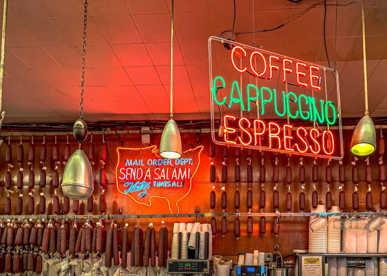 a bar with neon signs and other items hanging from the ceiling