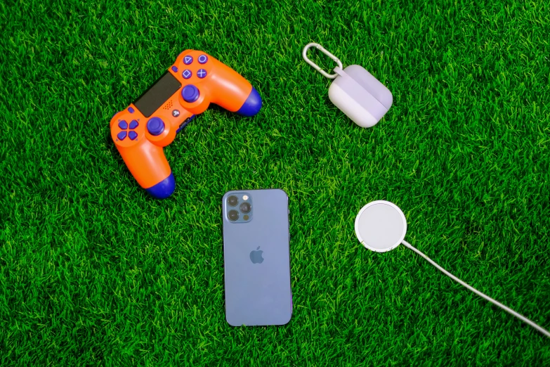 apple phone, game controller, earbuds, and camera