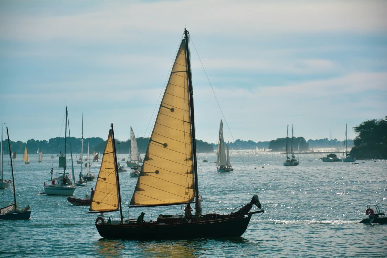 a group of sail boats traveling on a lake