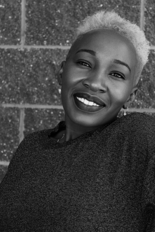 a beautiful woman smiling with her hair tied back