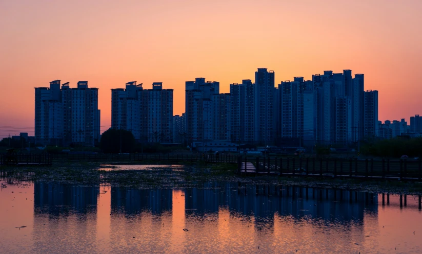 a body of water with a building in the background