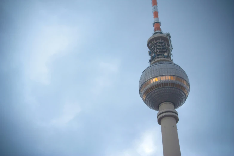 a tall television tower is against the sky