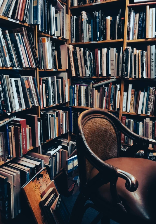 many bookshelves filled with books on the wall