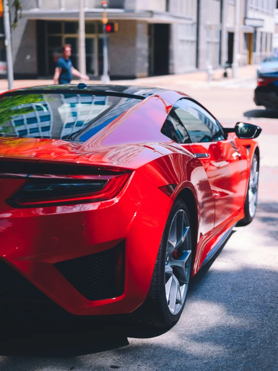 a sports car sits parked next to the curb