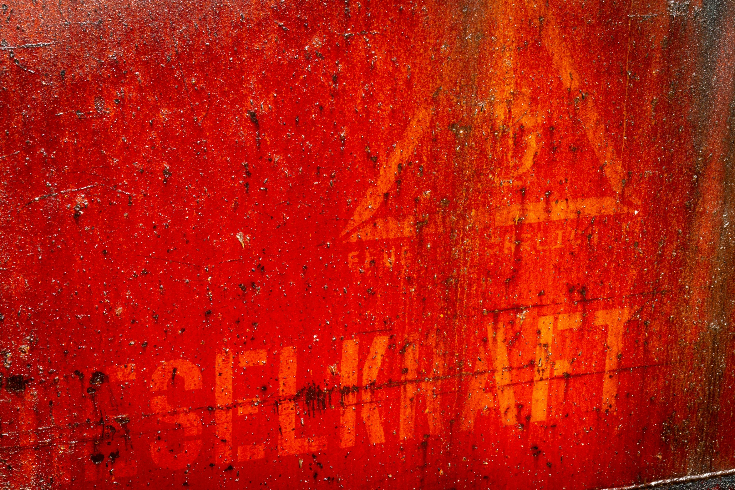 raindrops on the door surface of a red painted building