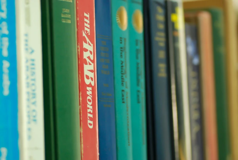a row of colorful books sitting on a shelf
