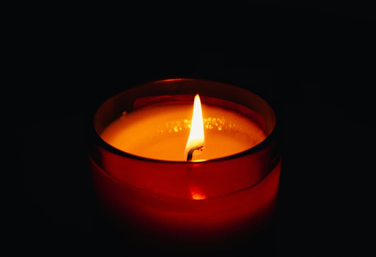 a small candle lit on the surface