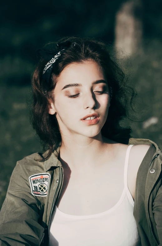 an artistic portrait of a young woman with makeup and patches