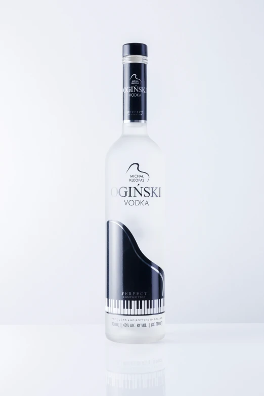 a white bottle with black piano keys on it