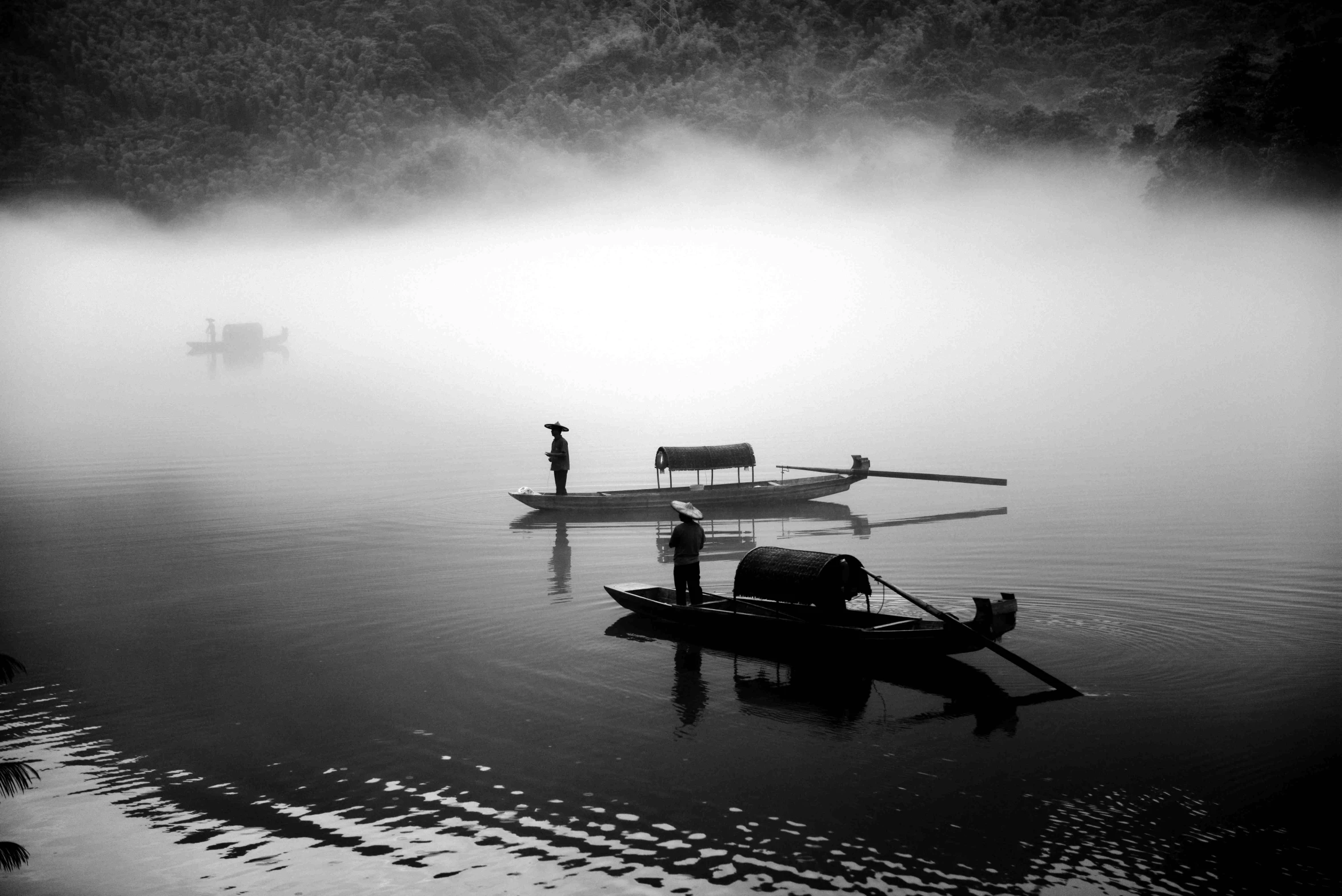 a black and white picture of some people in a boat