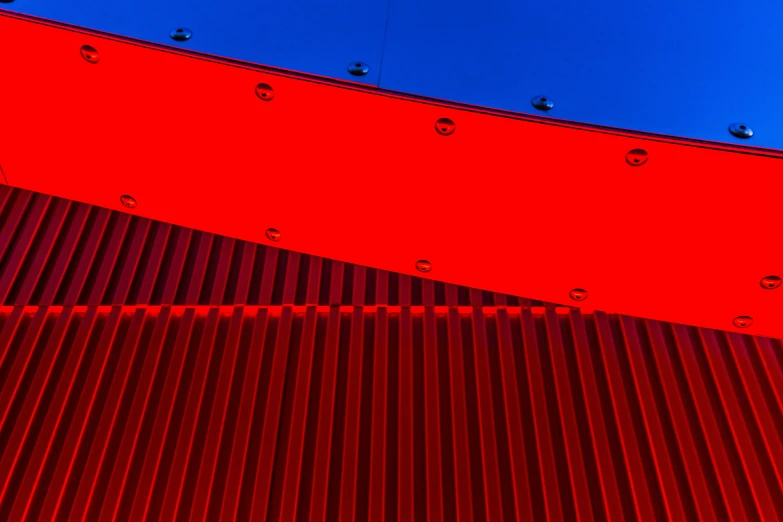 some red metal strips and blue sky in a building