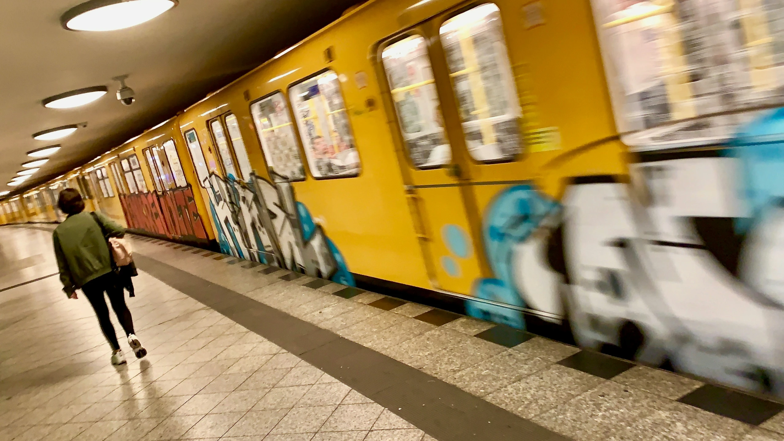 the subway train is passing a group of people