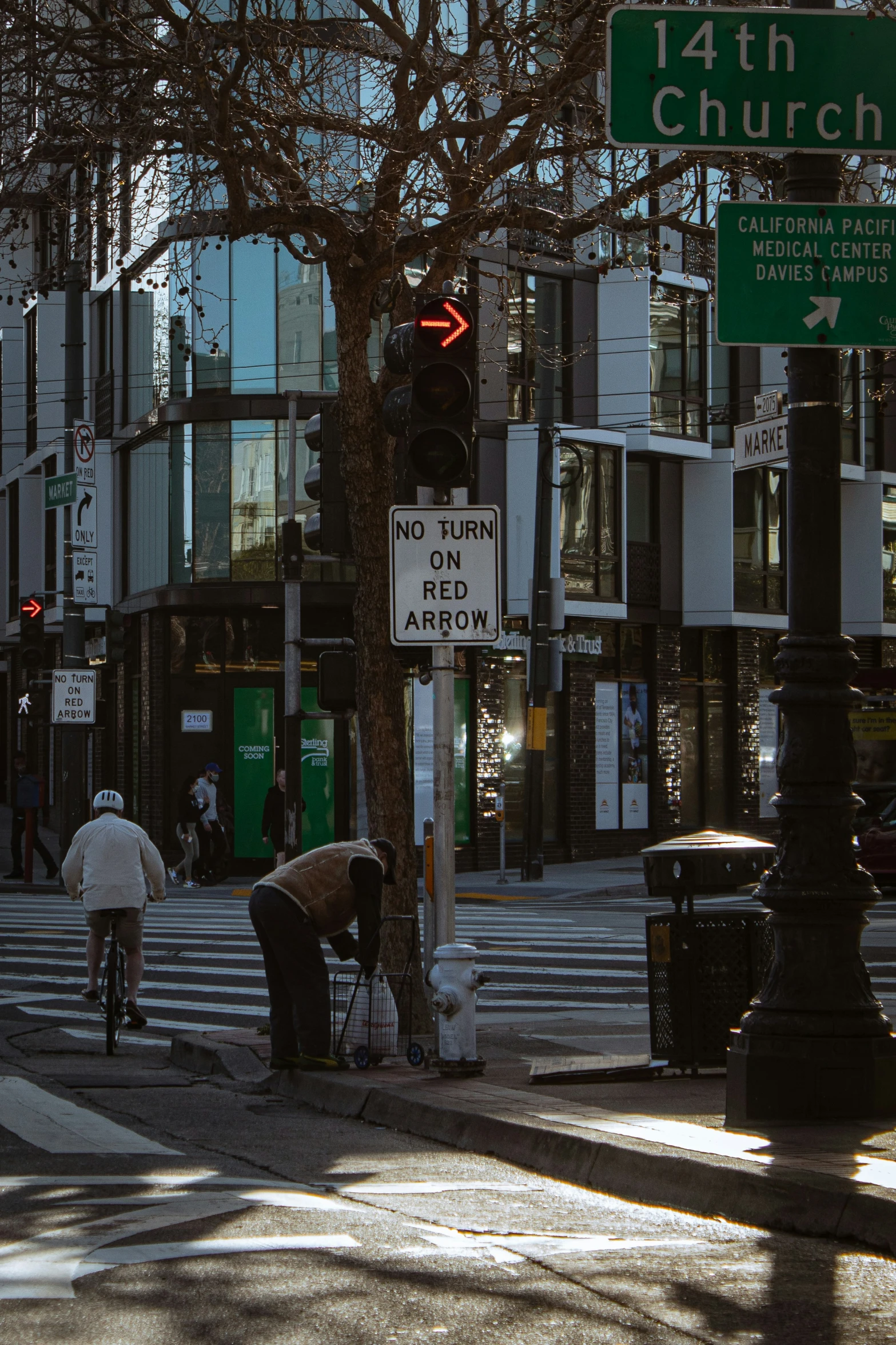 there are street signs and people on the sidewalk