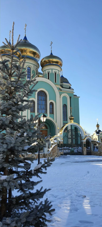 the front view of the church from a snow - covered driveway