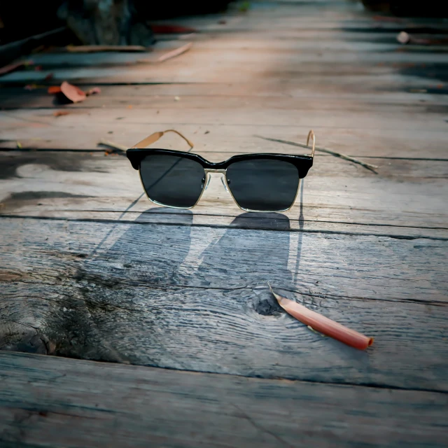 a pair of sunglasses on a wood table