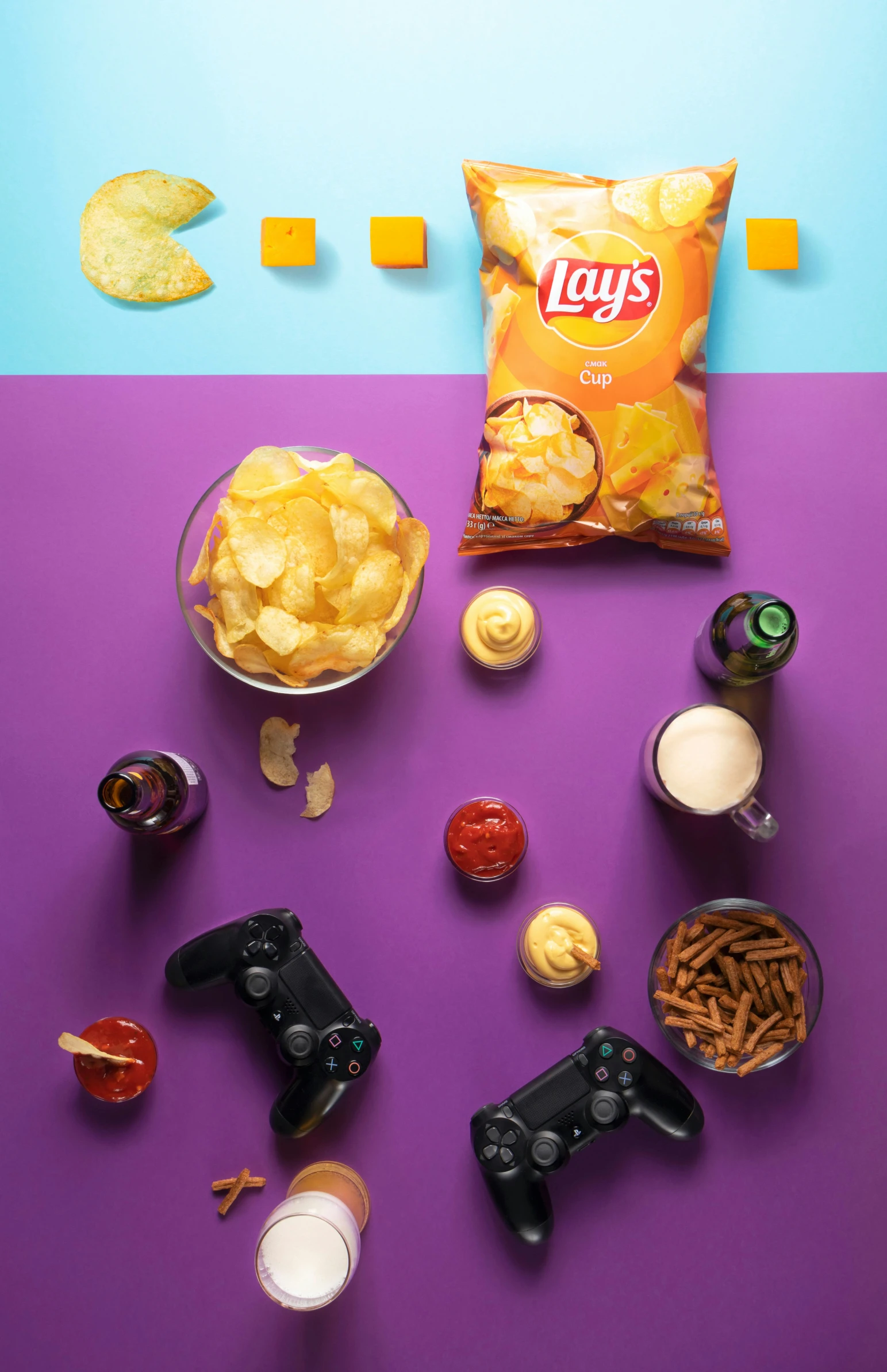 chips and snacks on table near video game remotes