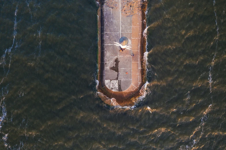 an aerial view shows the water and an air force plane wing, taken from above