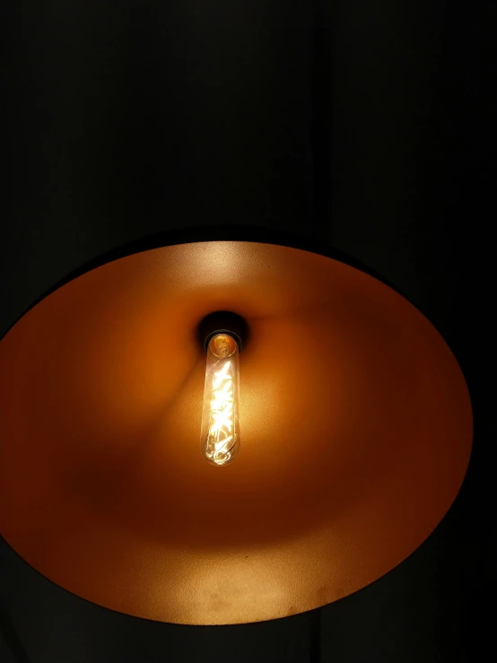a bright light shines from under a large round lamp