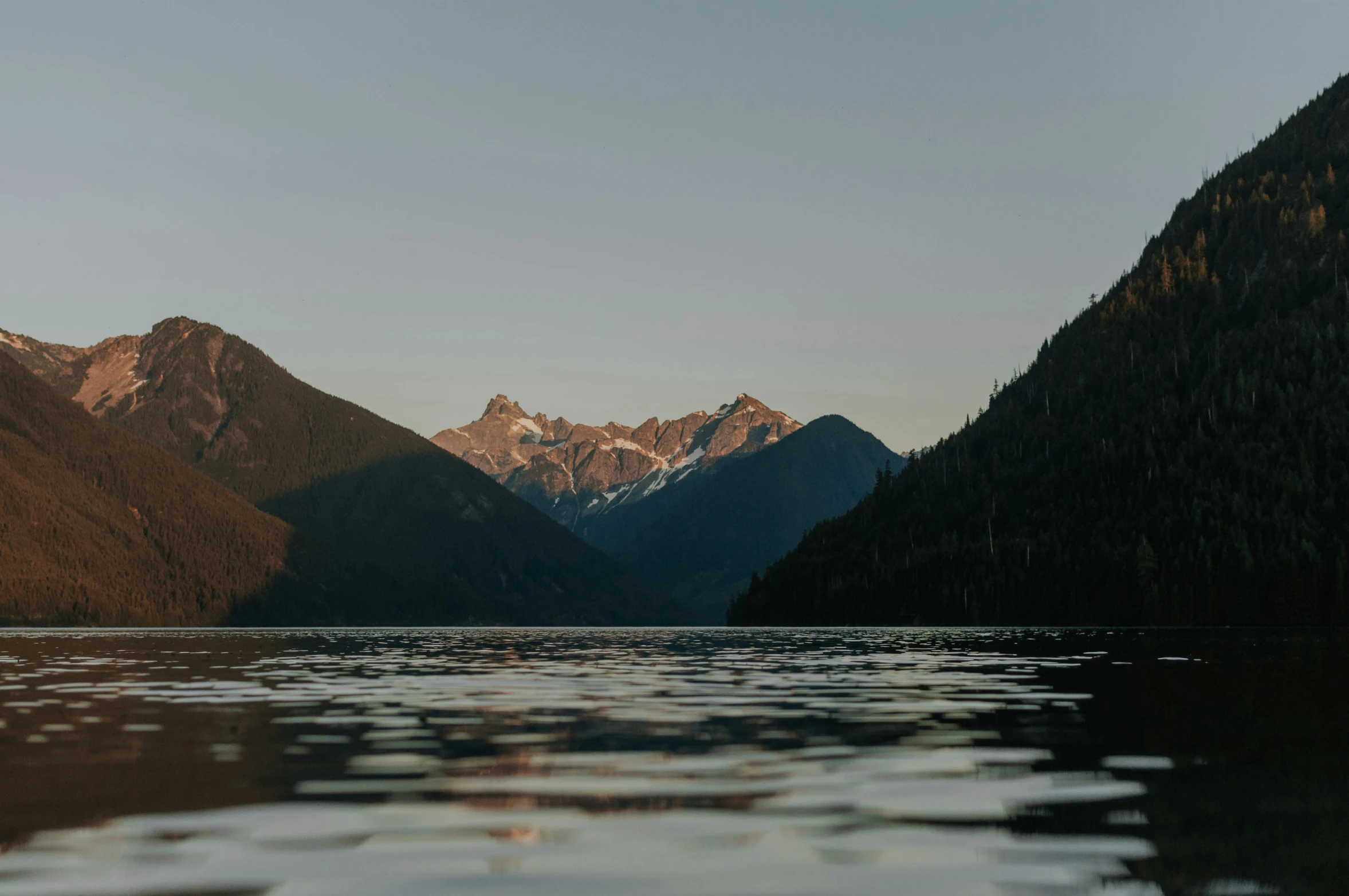 there is a small boat on a still lake