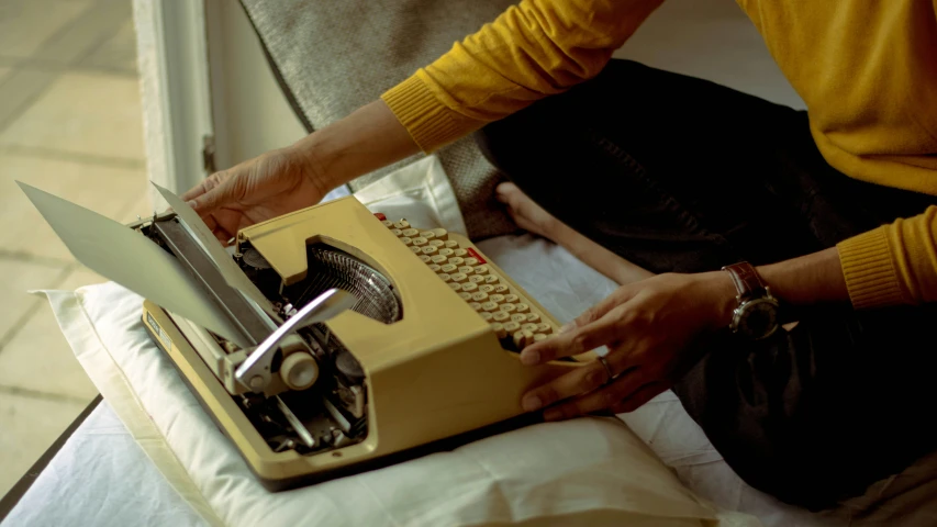 someone is using a typewriter to print a document