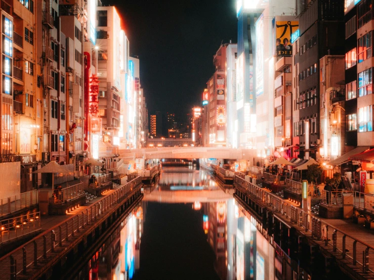 a city has lights reflected in the water