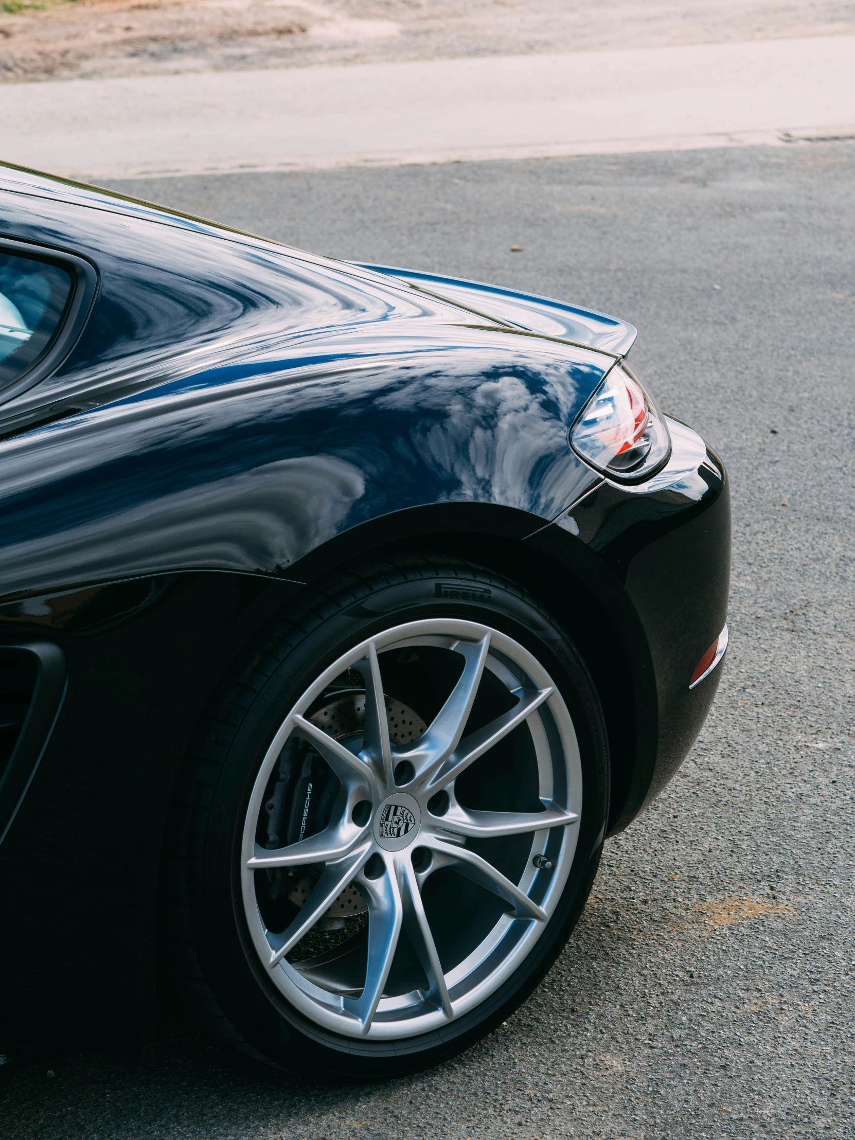 the rear view of a sports car, with chrome spokes