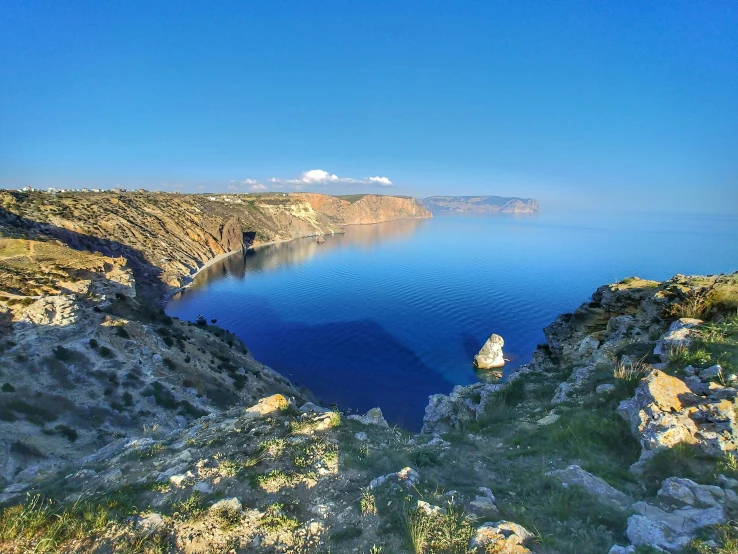 a lake surrounded by rocky mountains and water