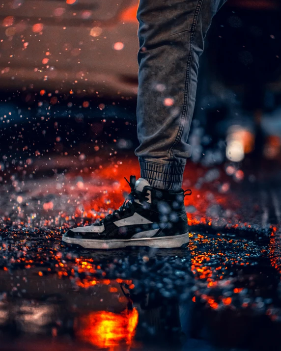 a person standing on the pavement in the rain