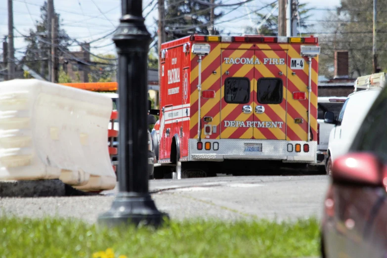 two ambulance vehicles near a car in a parking lot