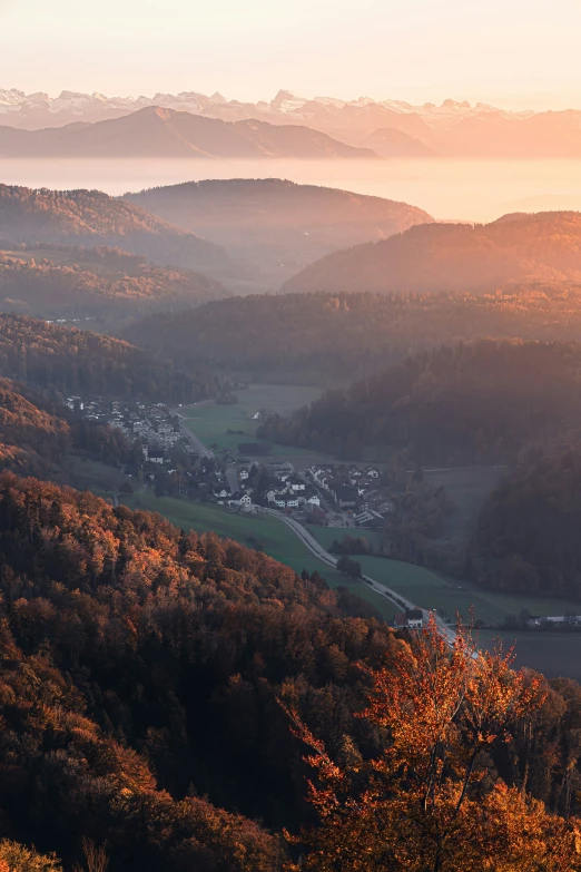 a landscape with some mountains and houses