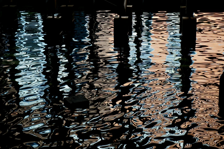 a clock and pole covered in water on a boat