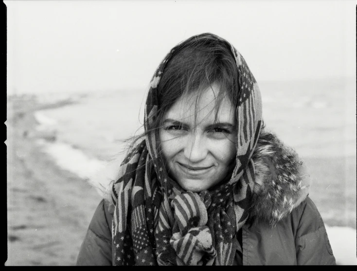 black and white pograph of a woman in an over sized scarf