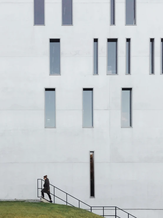 a man walking down some stairs outside a building