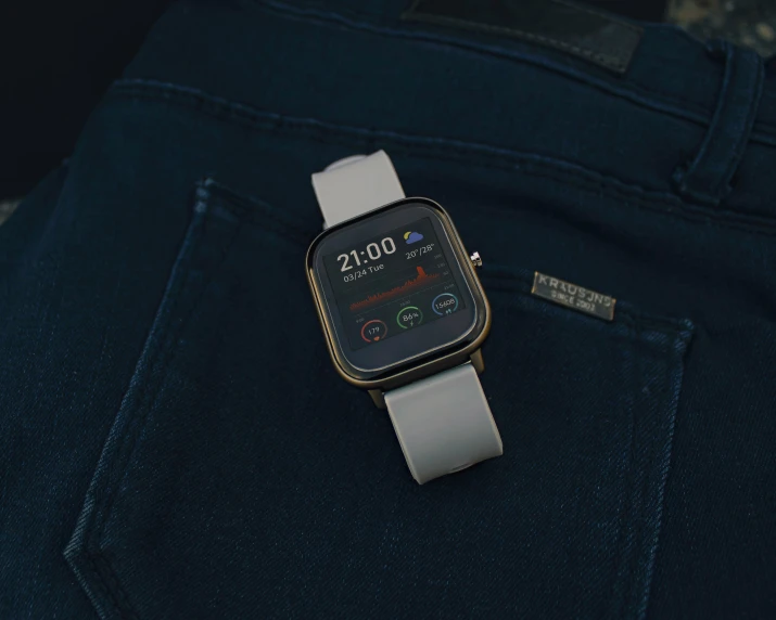 a smart watch sits on the back pocket of jeans